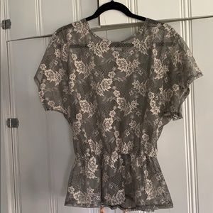 Semi sheer lace top with gathered waist.